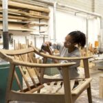 Workers in a small light industrial furniture factory specialising in wood joinery and carpentry